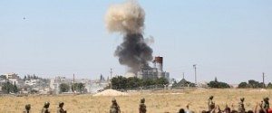Smoke rises in the Syrian town of Kobani as it is seen from the Turkish border town of Suruc in Sanliurfa province, Turkey