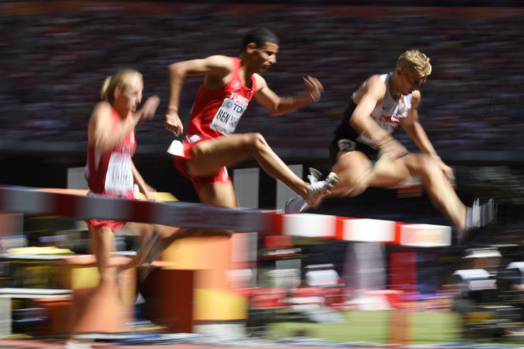 Tunisia's Amor Ben Yahia (C) competes in the heats of the men’s 3,000 metres steeplechase athletics event at the 2015 IAAF World Championships at the "Bird's Nest" National Stadium in Beijing on August 22, 2015. AFP PHOTO / OLIVIER MORIN