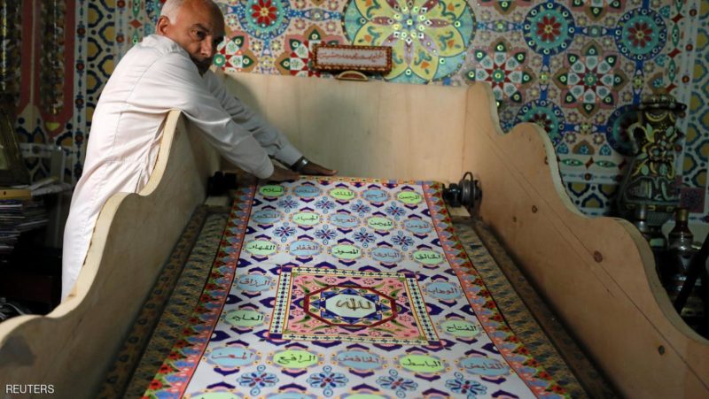 Saad Mohammed rolls down what he says is the largest handwritten version of Koran in the world, in the town of Belqina