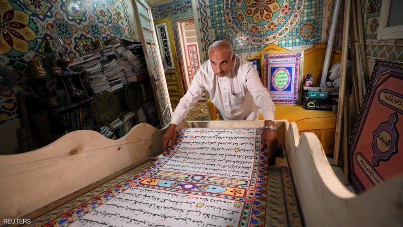 Saad Mohammed rolls down what he says is the largest handwritten version of Koran in the world, in the town of Belqina